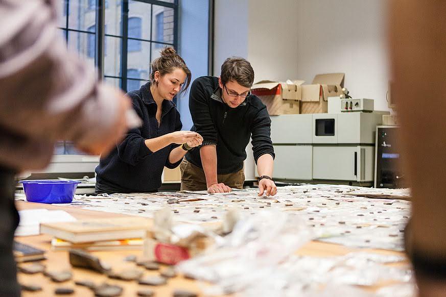 Jona sorting archaeological finds in the lab