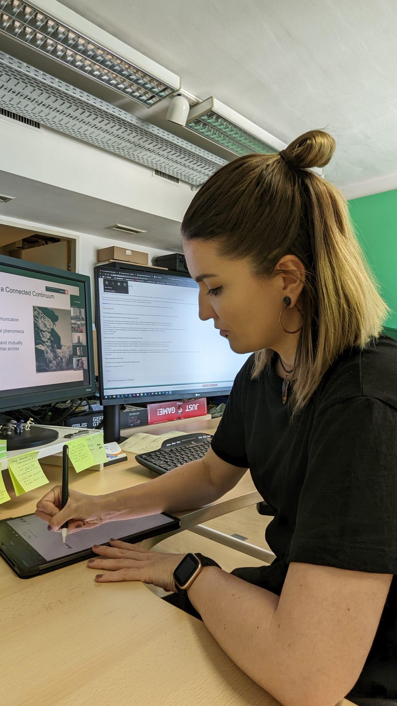 Jona working on digital illustrations at the desk