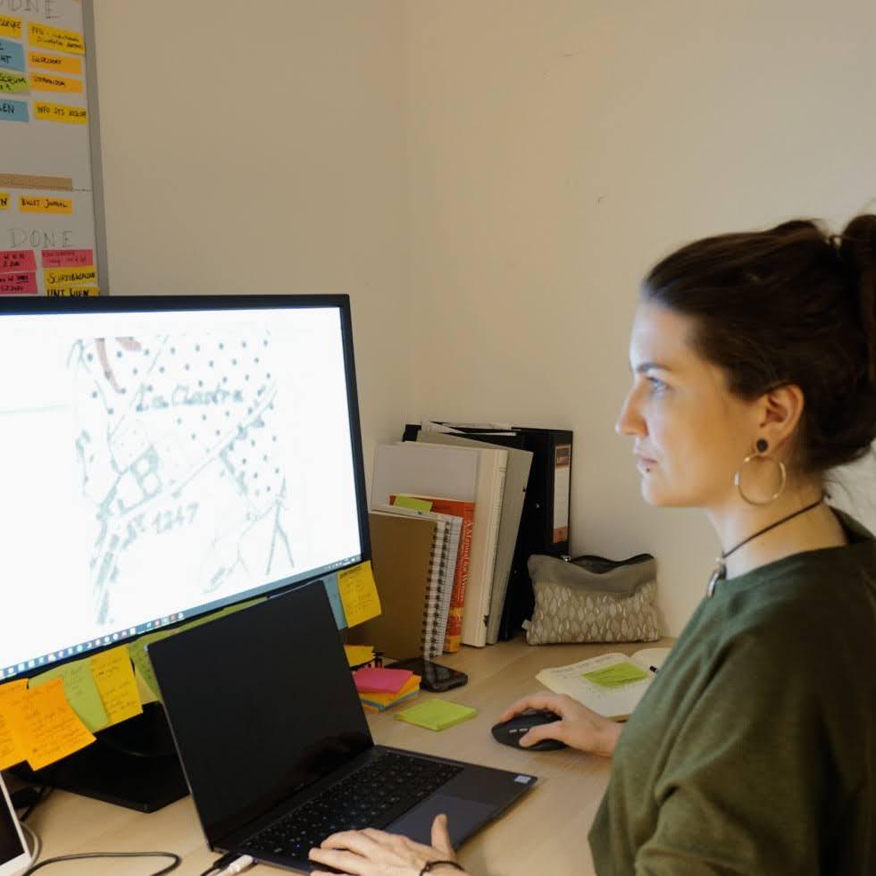 Jona working with archaeological maps at the desk